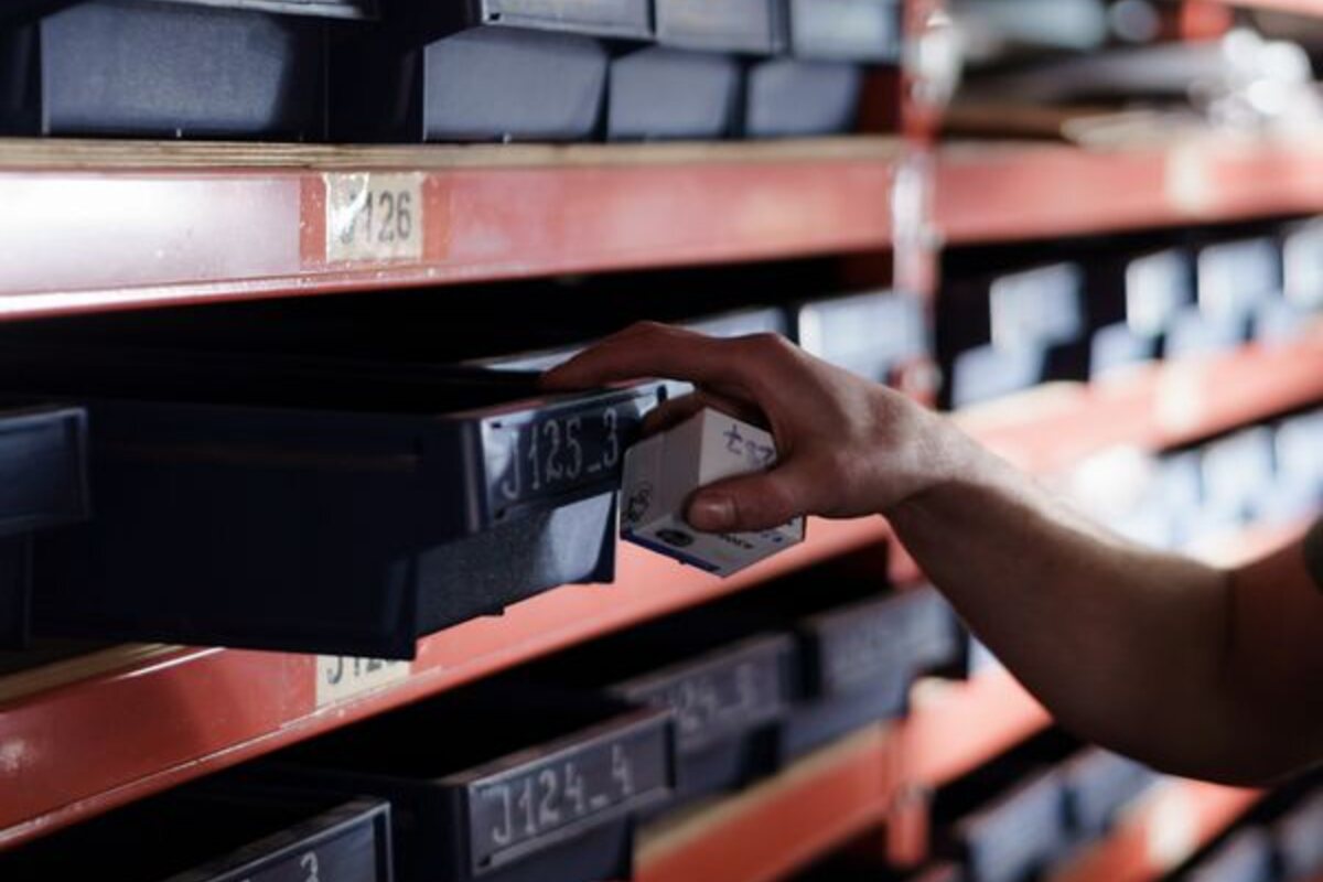 A product being selected from organized industrial inventory bins