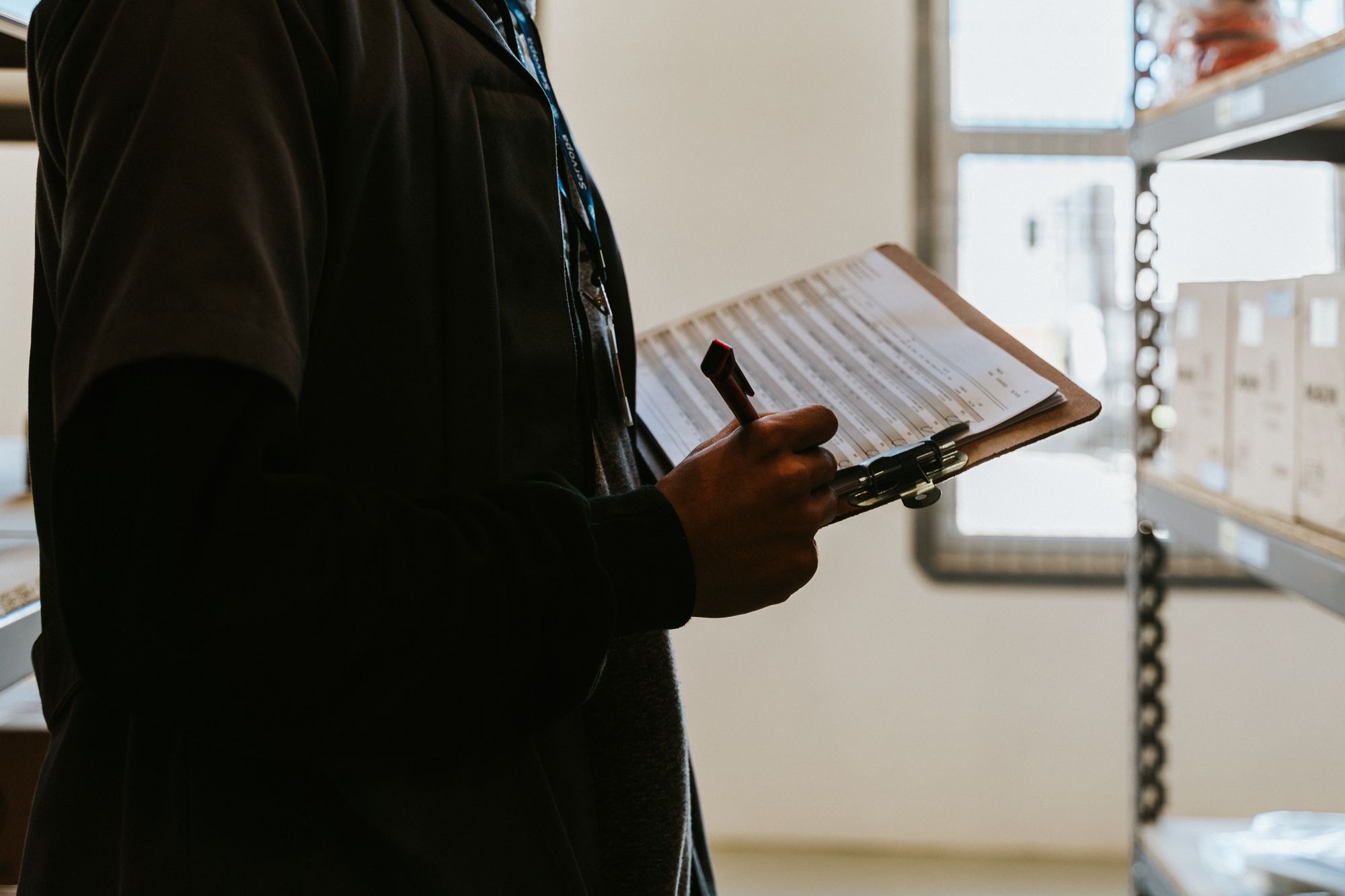 Industrial worker reviewing an inventory checklist