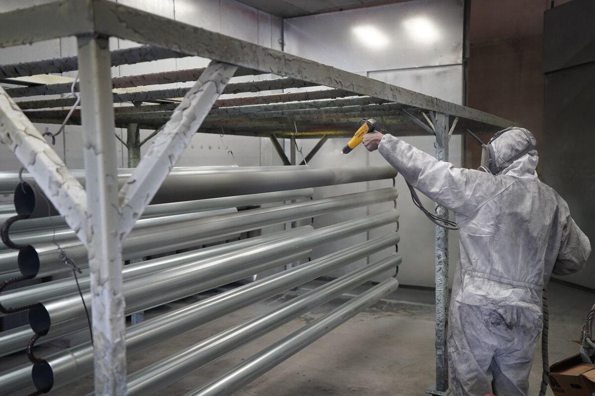Powder coating equipment being used on metal components