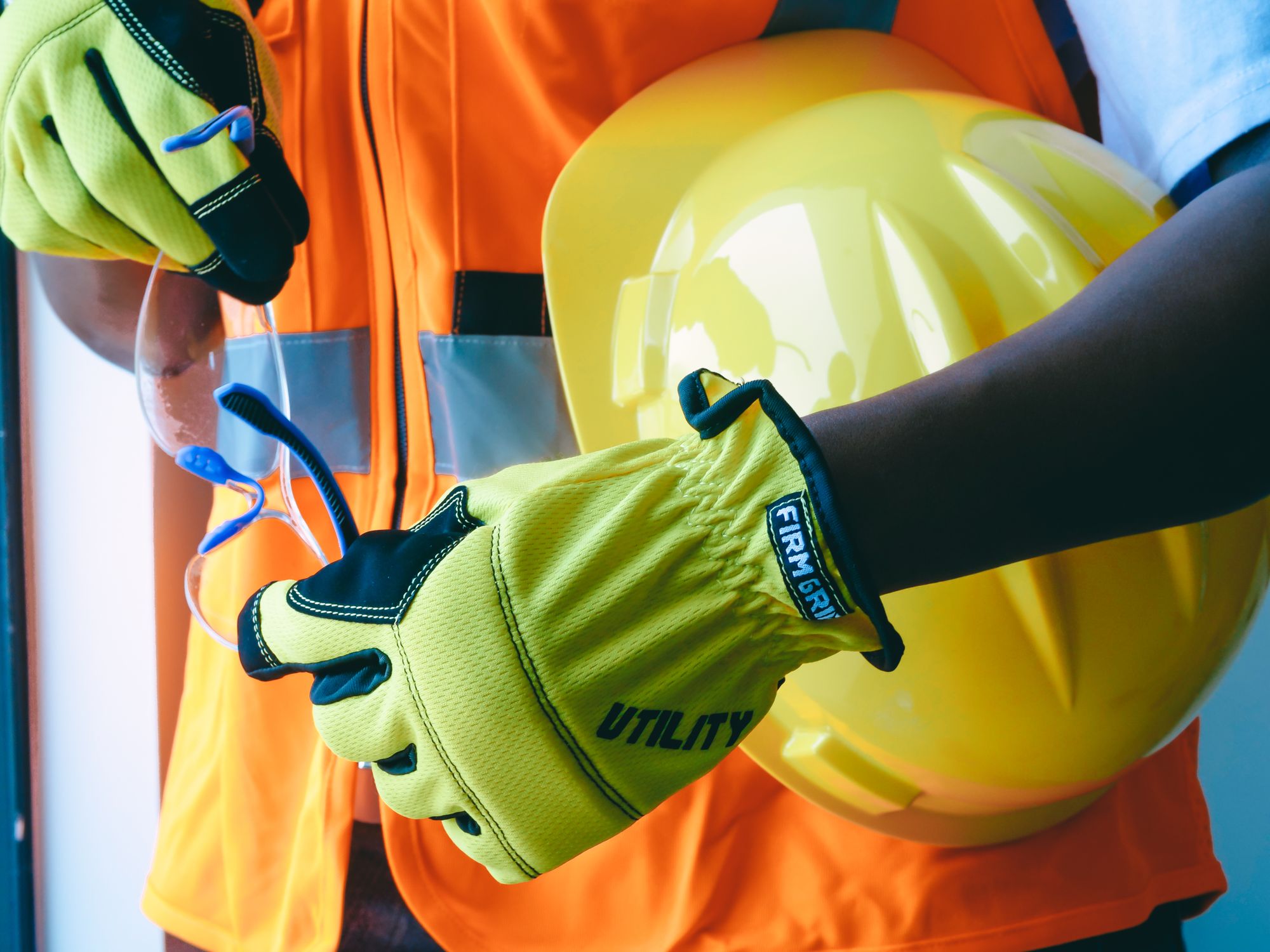Protective gloves and safety helmet arranged for industrial work