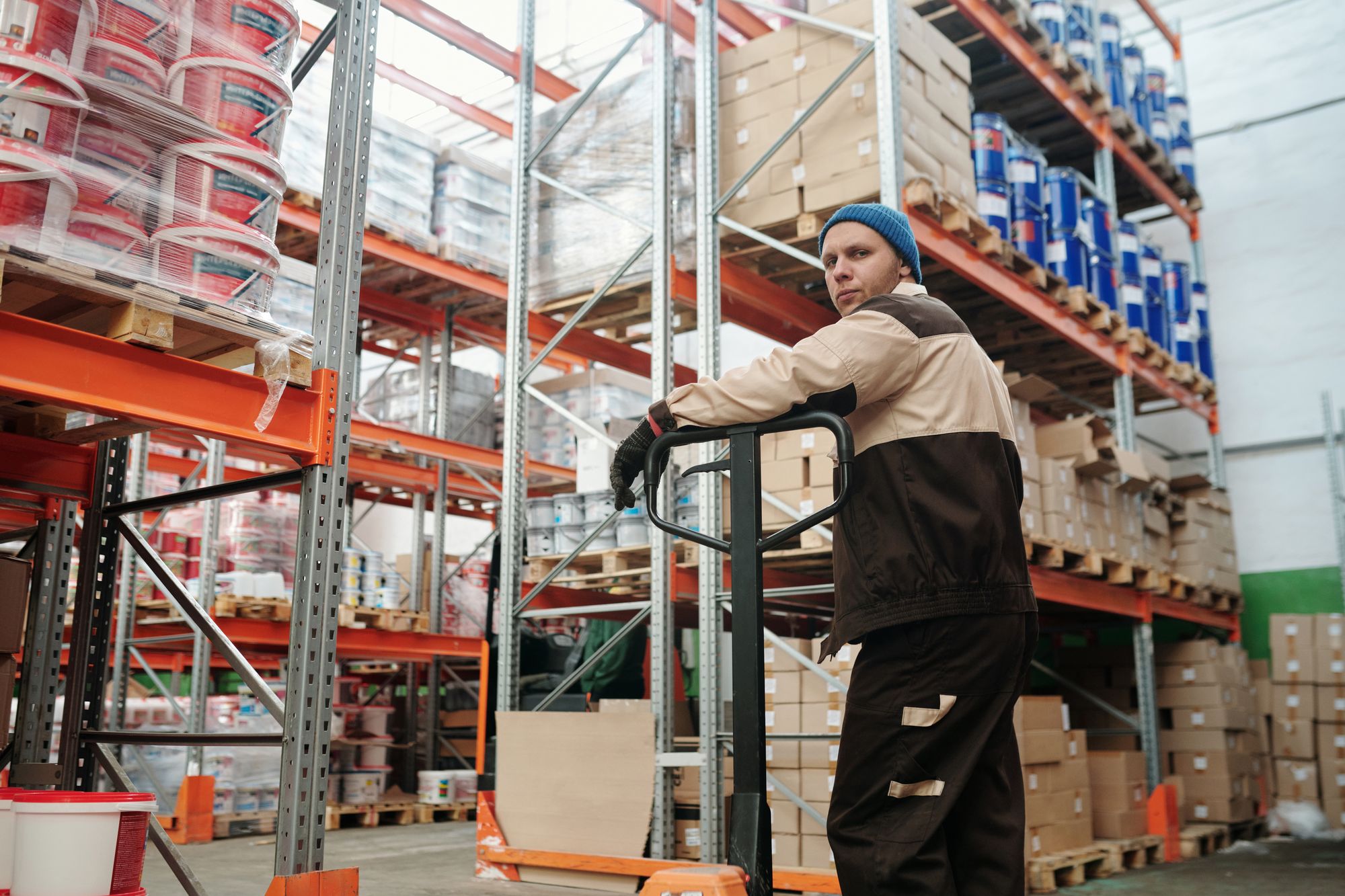 Warehouse worker moving goods with a pallet jack