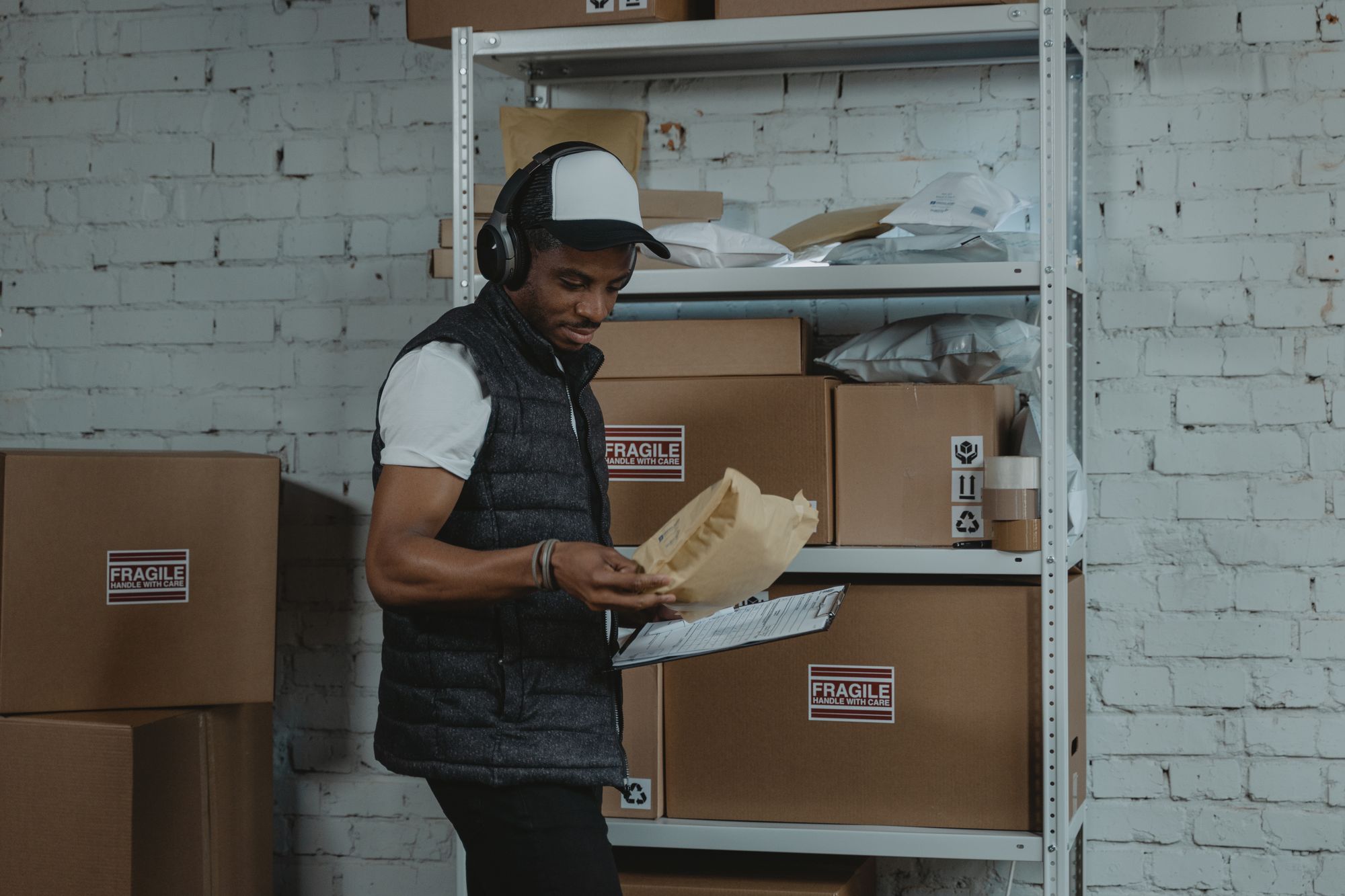 Warehouse worker reviewing and preparing products for shipment